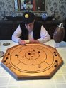 Pat and TerryI have played over 60 crokinole games in the last three weeks.  Here Terry is focused on making the most of his final shot.  This Canadian-invented game became vital to the fabric of Canadian culture in the mid to late 1800’s.